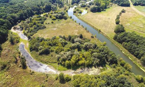 Aerial view of countryside with river ecosystem.