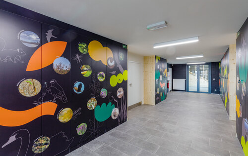 Visitors find dozens of colourful photos of wild plants and animals on the doors in the cloakroom. © Aleš Ležatka